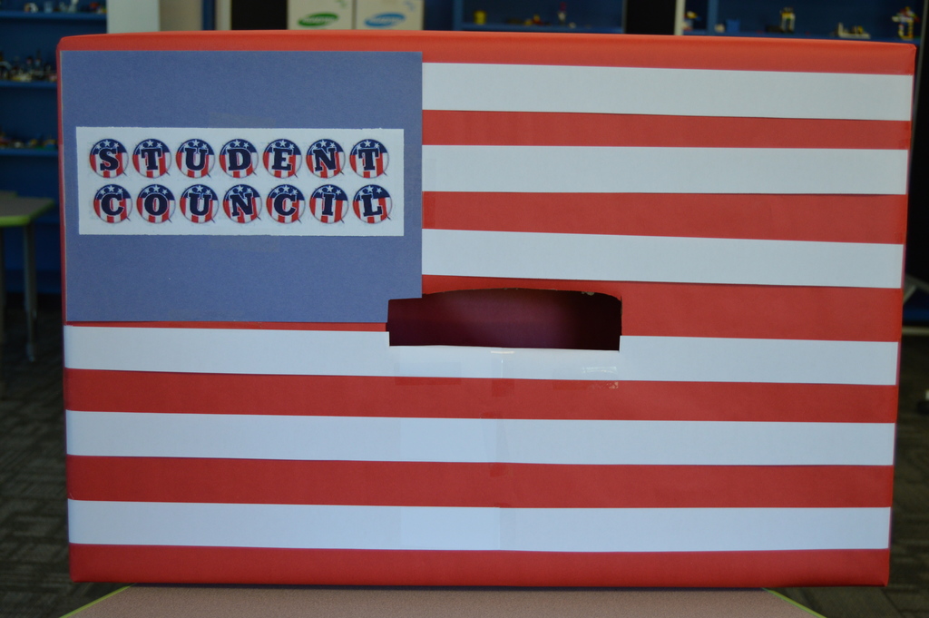 A box, decorated as the American Flag , with the words Student Council in the upper left-hand corner.