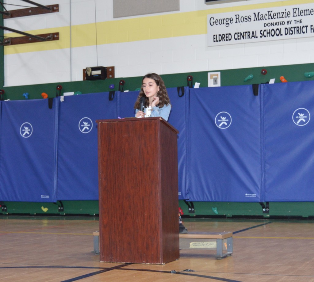 Riley Abato stands in front of a podium to deliver her student council speech.