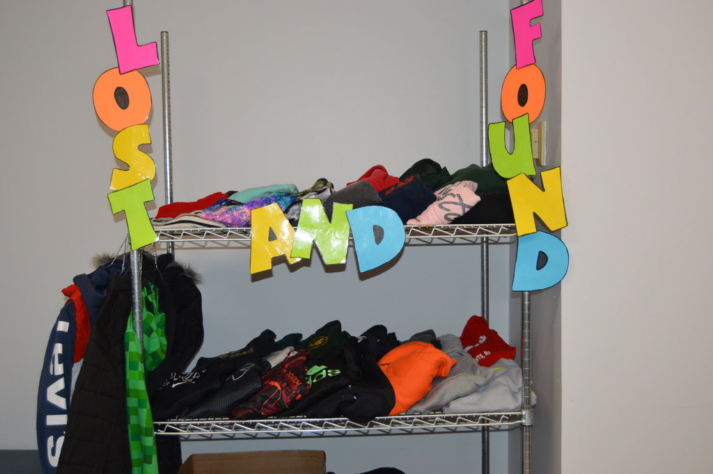 Image of a rack of clothing with a sign that reads Lost and Found.