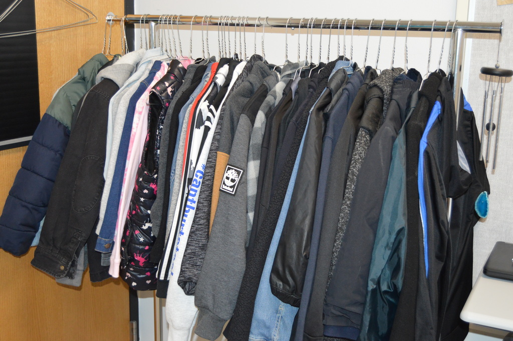 Image of a rack of coats on hangers
