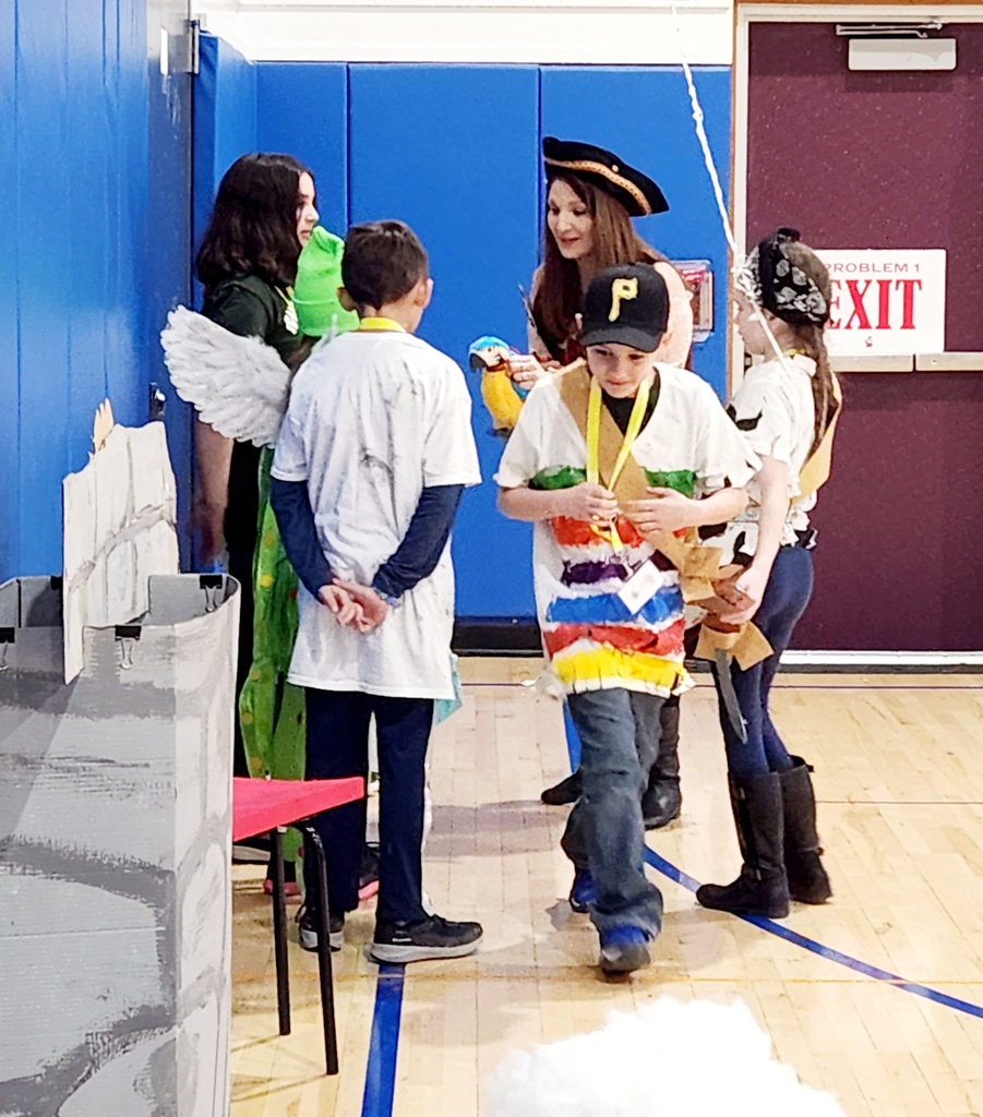 Students dressed in pirate costumes present their OM skit