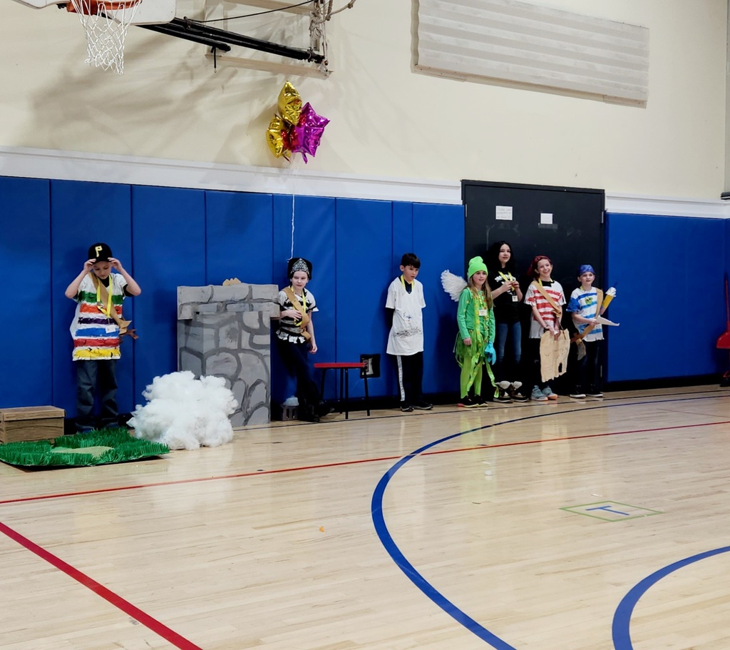 Students dressed in costume present their OM skit