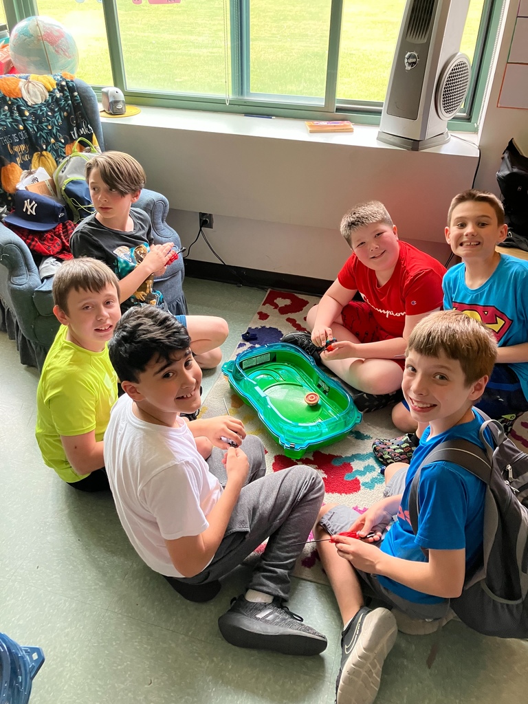 Image of students playing Beyblades in a tournament rink.