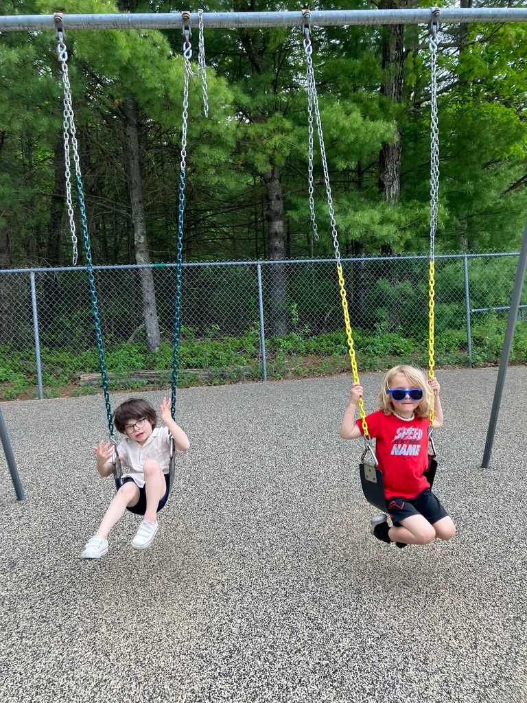 Image of two students on the swings at playground club