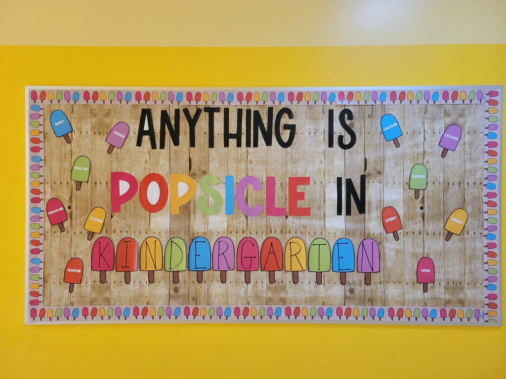Yellow wall with a bulletin board that reads Anything is Popsicle in Kindergarten
